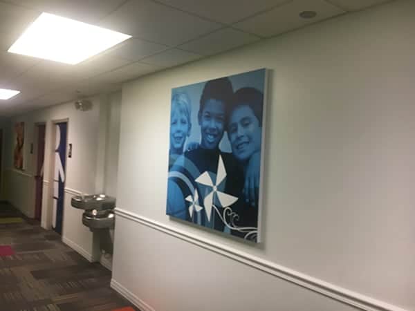 Faith Covenant Church3 Big corporate art of three boys in hall